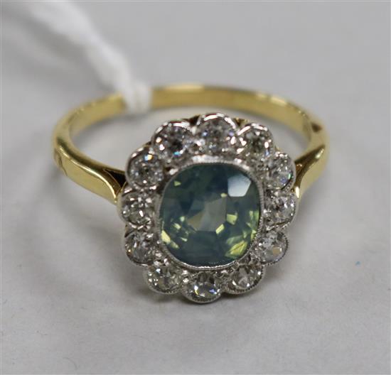 An 18ct gold, diamond and pale blue/green zircon set oval cluster ring, size P.